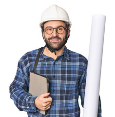 Hispanic male architect with blueprint and tablet in studio