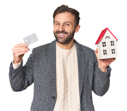 Hispanic male businessman with credit card and house model