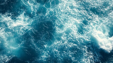 Fototapeta premium Waves crashing against the shore under bright sunlight on a clear summer day