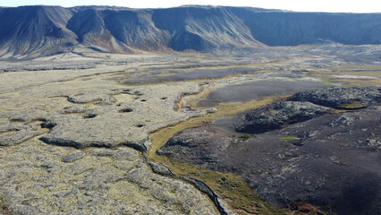 Vue aérienne au drone professionnel d’une voiture en Islande sur route désertique volcanique...