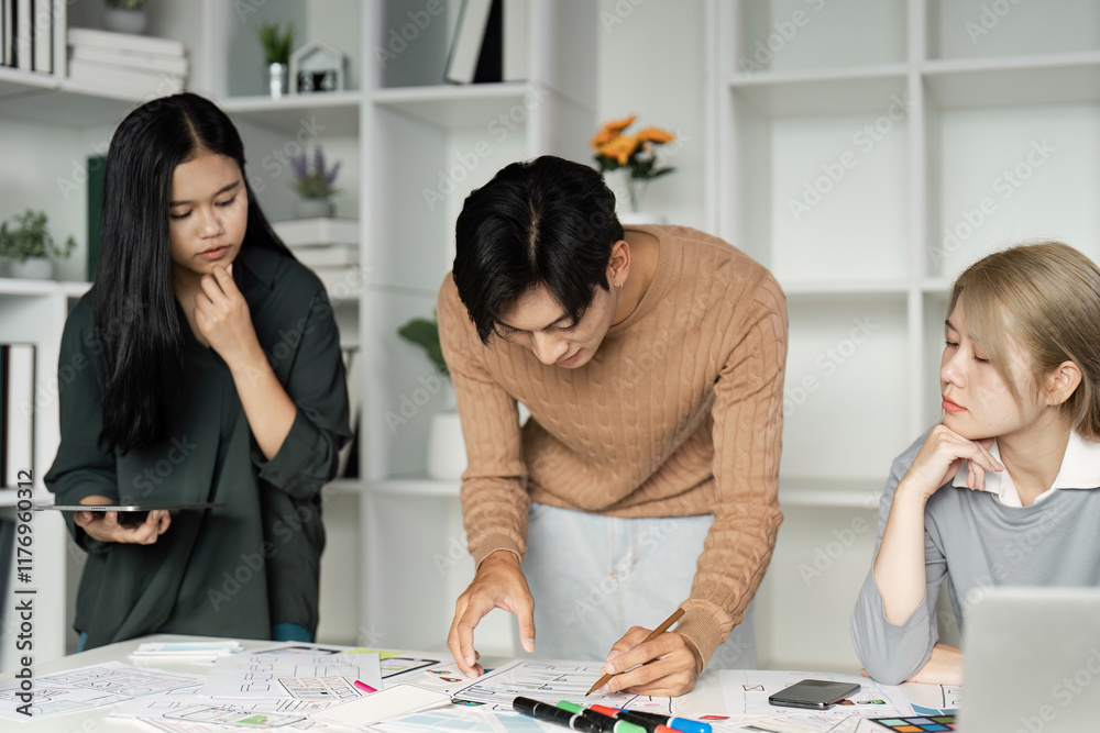 Wall mural creative team collaborating on ux ui design for business solutions in modern office environment