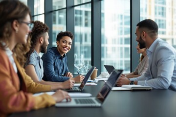 Business meeting with diverse team members in modern office setting with large glass windows and city view in background.