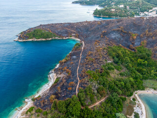 Burned slopes, hills, talus on  erimitis ,Corfu Island ,Greece. The new born life after fire, blaze. Ionian Islands, Greece. Site of the fire.