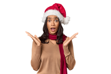 Filipino in Christmas attire and Santa hat surprised and shocked.