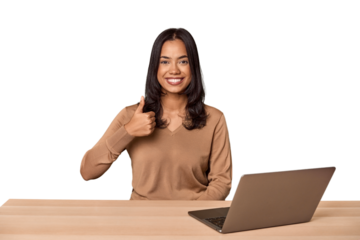 Filipino woman at desk with laptop smiling and raising thumb up