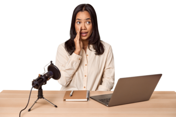 Woman records podcast with laptop is saying a secret hot braking news and looking aside