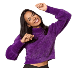 Young filipino woman celebrating a special day, jumps and raise arms with energy.