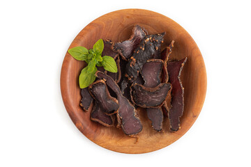 Armenian Basturma dried meat on wooden bowl isolated on white. Top view