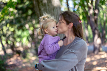 Mother and daughter sharing a kiss.
