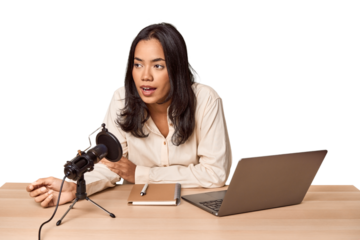 Filipino woman podcasting with mic and laptop