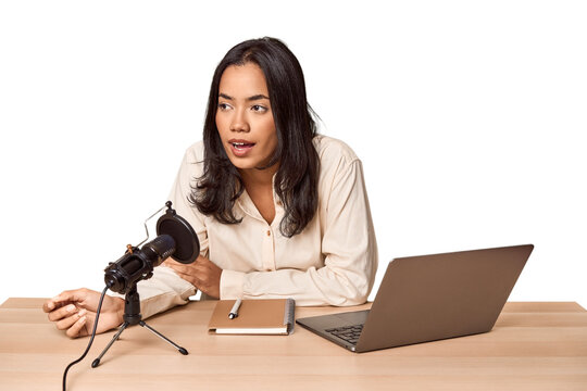 Filipino woman podcasting with mic and laptop