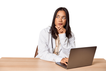 Thoughtful Filipino vet at desk, focused on care