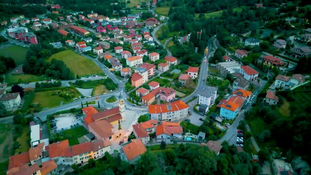 4K Aerial Drone Video of Traffic through the Villas and Farmhouses in the Village of Cavallasca, Italy on a Summer Evening