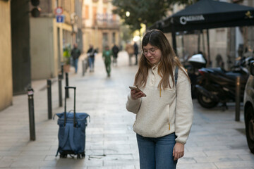 Fototapeta premium young foreign student girl in Spain looking on gps navigator the way . High quality photo