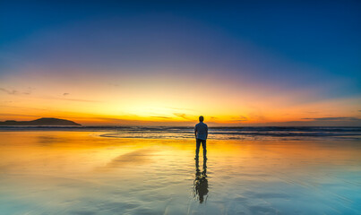 Summer travel vacation concept, Traveler asian man relax and sightseeing on Ke ga beach at sunset...