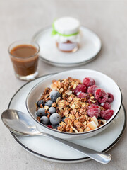 Healthy Breakfast Bowl with Granola, Yogurt, Berries, and Coffee
