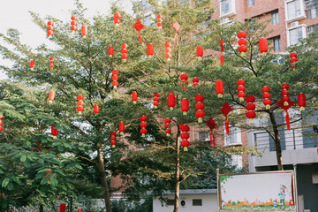 Asian Chinese New Year Lunar New Year, red lanterns hanging on trees in the park