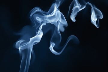 Fototapeta premium Abstract white smoke swirls on a dark blue background.