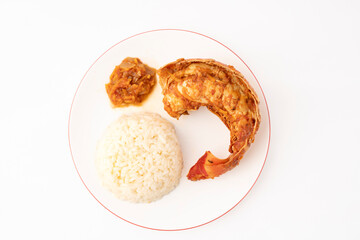 Gennevilliers, France - 01 02 2024: Still life. Close up of an American lobster tail plate with rice on a white background.