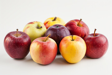 A small cluster of mixed apples in different colors, arranged neatly on a crisp white backdrop.