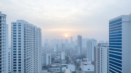 Fototapeta premium Extreme long shot of the cityscape at dawn. The sun, a orange orb, casting a warm glow . The city skyline is obscured by a hazy atmosphere, A misty morning paints a soft, sleeping city,aerial view.