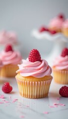 Delicious raspberry cupcakes with pink frosting on a white marble surface for Valentine or celebrations, focusing on a single decorated cupcake