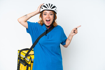 Young caucasian woman with thermal backpack isolated on white background surprised and pointing finger to the side
