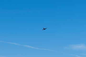 Commercial aircraft high in the sky landing grar down heading for Prestwick Airport in Ayrshire Scotland