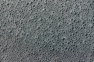 Bubbles forming an intricate pattern on a surface during a creative artistic process