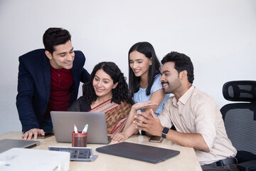 Happy Team Of Employees Looking At Laptop Screen