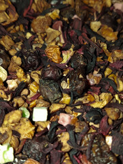Dry tea with dried fruits close-up. Dried rosehip berries for tea. Dry fruits for hot drinks. 