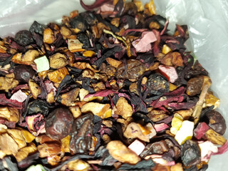Dry tea with dried fruits close-up. Dried rosehip berries for tea. Dry fruits for hot drinks. 