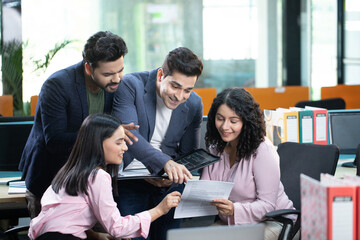 Fototapeta premium Happy Business Looking At Their Monthly Report Of Work