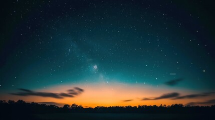 Naklejka premium Starry night sky over a scenic sunset landscape.