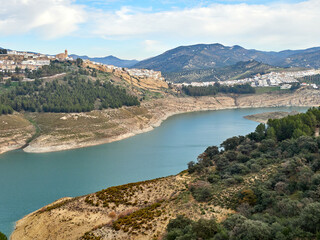 Iznajar village. Mountain village surrounded by the Iznajar Reservoir. Parish of Santiago Apostol. Iznajar Castle