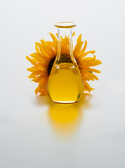 Sunflower Oil In A Clear Bottle Beside A Bright Sunflower blossom