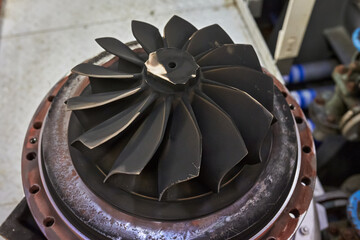 Close up of a Turbocharger turbine wheel, with blades covered in carbon soot deposits. © Igor Hotinsky