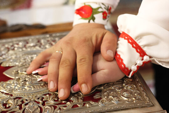 During the wedding, the newlyweds put their hands on the Gospel, making their wedding vows.
