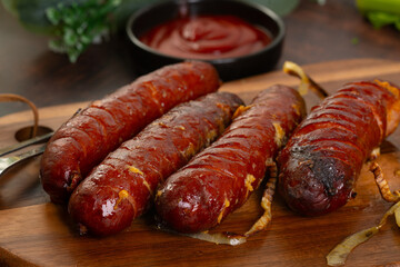 Grilled sausage on wooden board