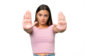 Young caucasian woman isolated on green chroma background making stop gesture and disappointed