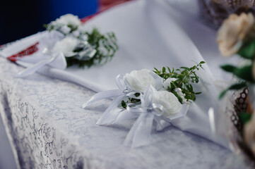 Elegant White Floral Corsages on a Delicate Table Setting