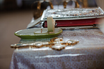 Serene Religious Setup with Candle, Cross, and Decorative Elements