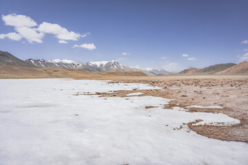 High-mountain landscape panorama in length with snow and mountains in the Pamirs in Tajikistan, desert mountains without vegetation with rocks and glaciers