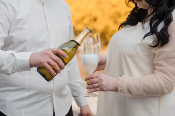 Romantic Celebration with Champagne Pouring Between Couple