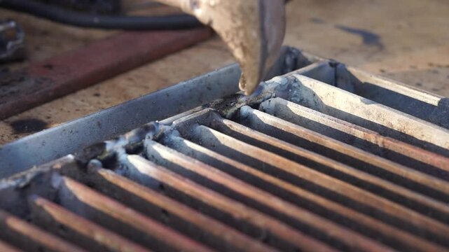 Removing slag after welding close up