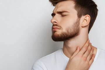 Fototapeta premium Handsome man with neck pain. Concept of sore throat, pharyngitis, laryngitis, thyroiditis, choking