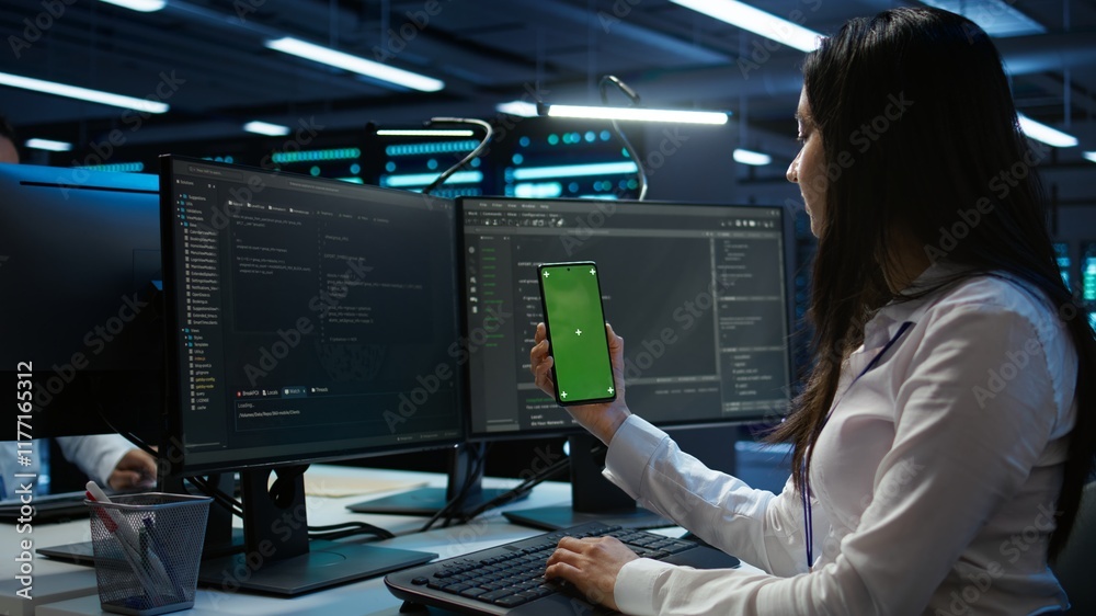 Poster worker overseeing data center using green screen mobile phone, ensuring system can handle networking