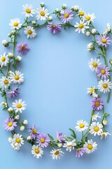 Fototapeta premium Artistic frame of spring flowers on a muted pastel lilac background, offering a serene layout for card designs. Top view, flat lay style.