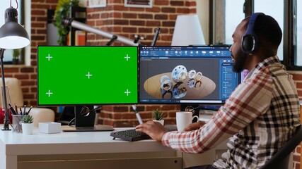 Software developer creates a gear prototype on dual monitors next to chroma key display, home office remote work. Expert does 3D modeling for innovation in the industrial design industry. Camera B.