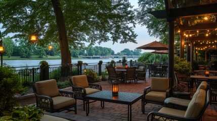 Obraz premium Cozy outdoor patio with plush seating, vibrant greenery, and a calming riverfront ambiance for relaxation.
